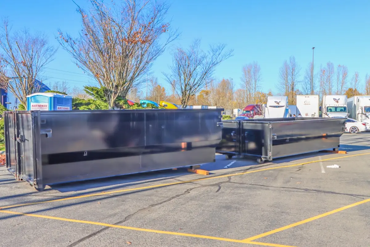 Professional dumpster rental service with roll-off container on residential driveway in Chardon